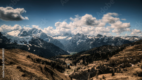 Passo Gardena, (Bz) in June 2022, you can see the morning light on the morning clouds, with the mountains with the last spring snow. You can see the valley, dried up by a particularly dry winter that 