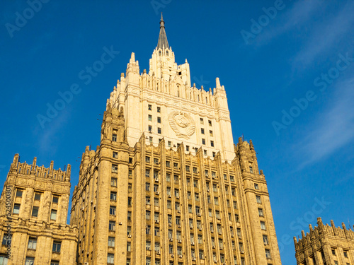 Moscow cityscape within day time. Offices buildings exterior. Building of the Ministry of Foreign Affairs  MFA. Rooftops of residential houses on blue sky, bottom up view coat of arms of the USSR