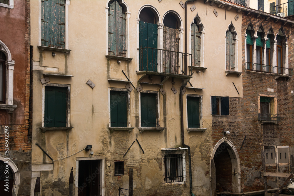 Facade of ancient buildings at the historical city of Venice, Veneto, Italy.