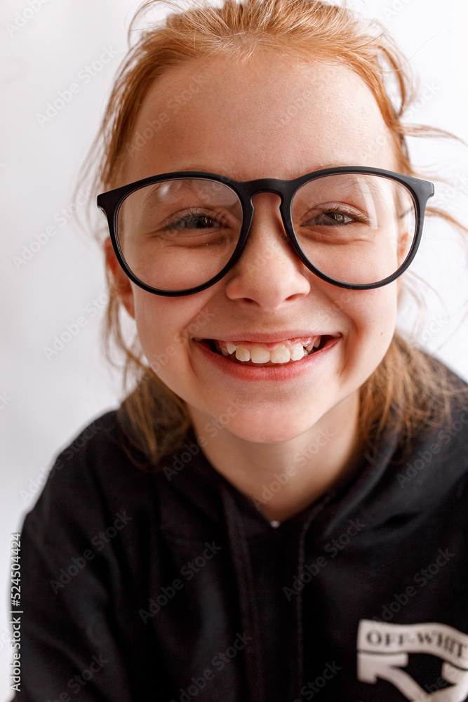 Funny smiling kid girl with glasses on white background