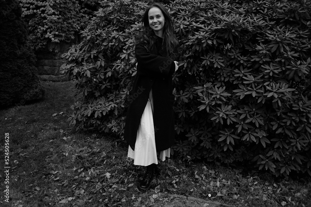 Yong girl in the autumn park on the background of plant leaves. Black and white emotional portraits Yong girl in the autumn park on the background of plant leaves. Black and white emotional portraits