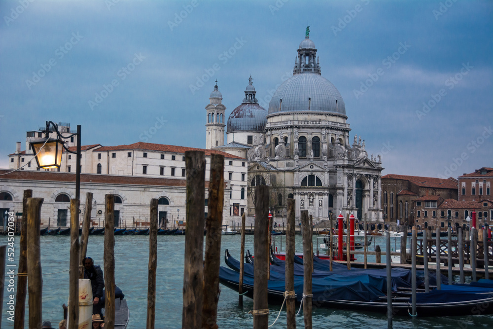 Two domes and a tower and gondolas in the Grand Canal of Venice, Veneto, Italy.