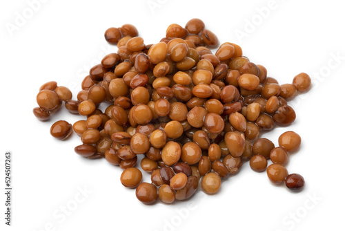 Heap of preserved steamed brown lentils close up isolated on white background