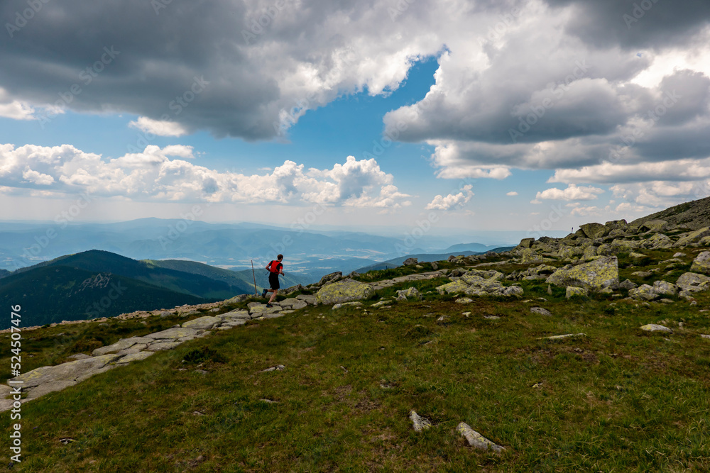 A young athlete enjoys running on the crest of the Chopok mountain in the Low Tatras in Slovakia