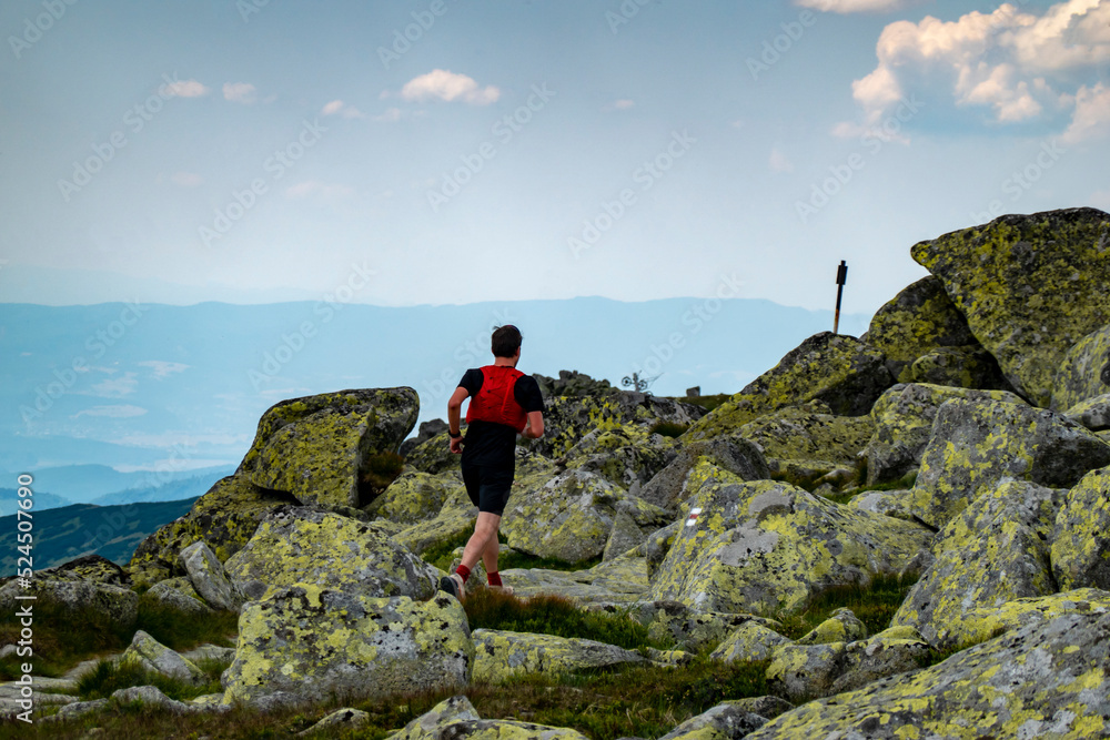 A young athlete enjoys running on the crest of the Chopok mountain in the Low Tatras in Slovakia