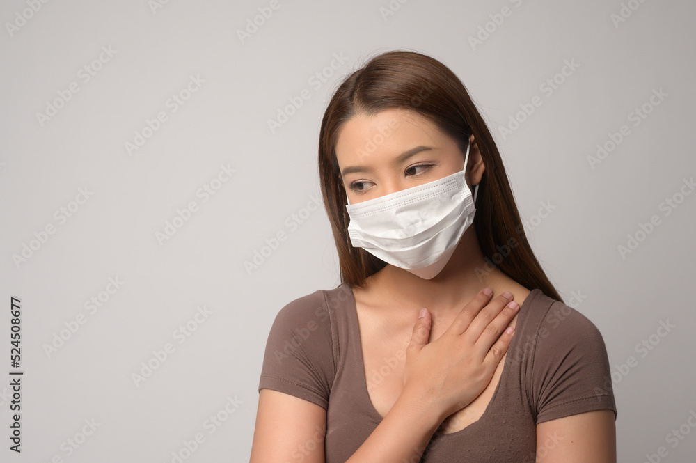 Young asian woman wearing protective mask over white background studio, safety travel , new normal , social distancing , covid19 and pandemic concept. Young asian woman wearing protective mask over white background studio, safety travel , new normal , social distancing , covid19 and pandemic concept.