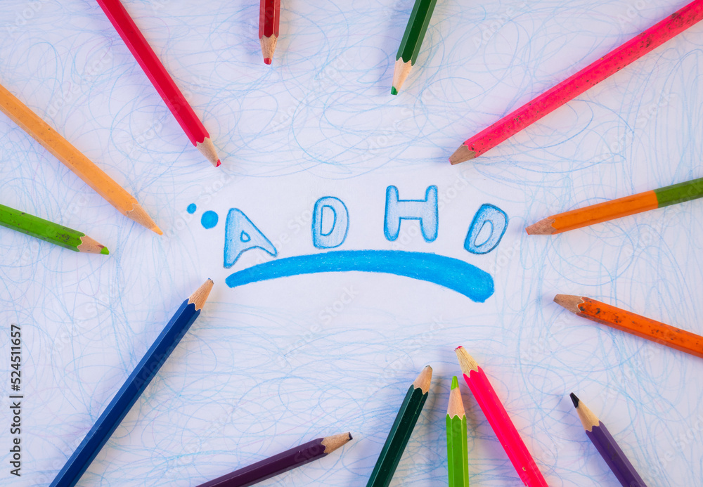 ADHD illness concept with words written in wood color on white paper ADHD illness concept with words written in wood color on white paper