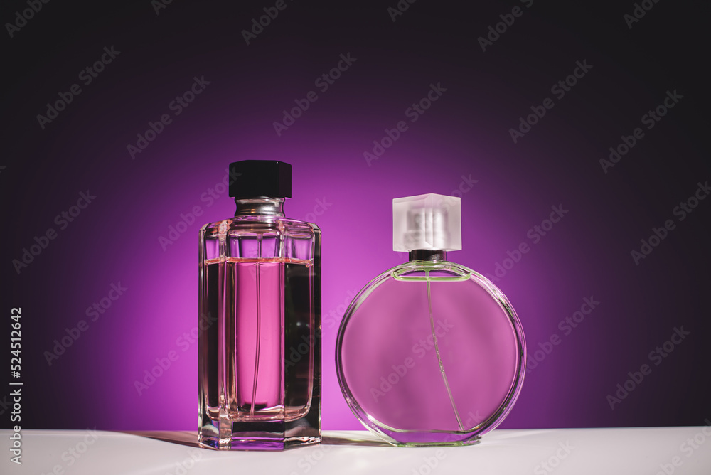 Two bottle of perfume on pink background Two bottle of perfume on pink background