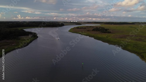 Wallpaper Mural Boat Powers through River in front of Marsh at Sunset Torontodigital.ca