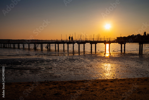 High quality photo of a pier at sundown. Wooded bridge seaside with Sunset  Strunjan. Slovenia