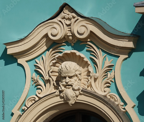 The decor of the facade of the building, decorated with the image of a male face photo