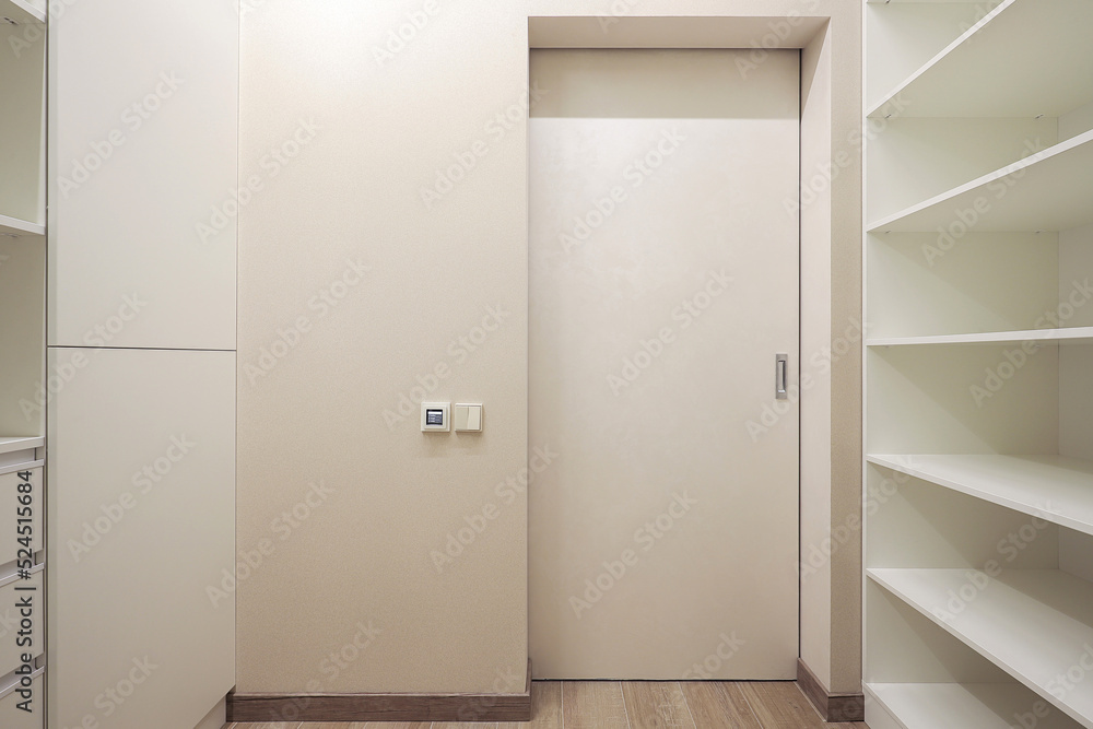 Fototapeta premium White door inside dressing room in the interior