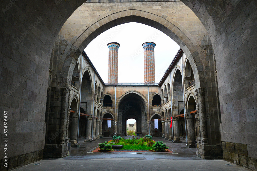 Twin Minaret Madrasah and Turkish flag in Erzurum , Turkey - The madrasah was built in 1271 by Khudavand Khatun, the daughter of Seljuq Sultan Kayqubad I. 