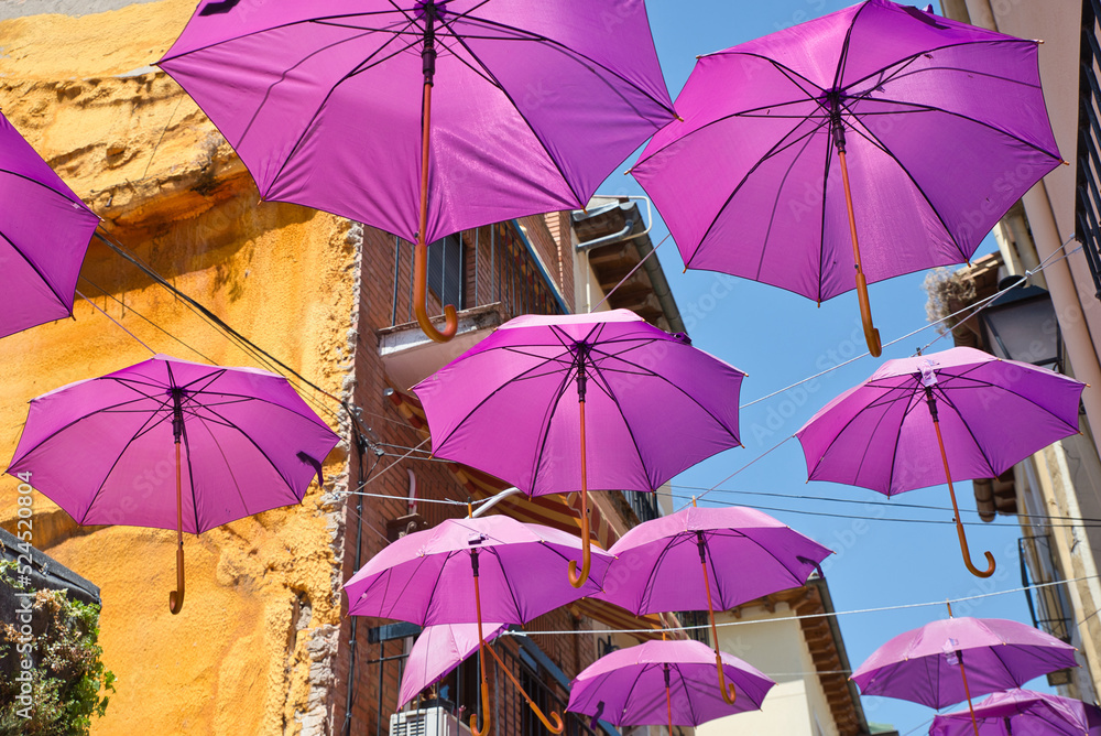 Pink Umbrellas over the city. Umbrellas in the sky, colorful view. Supporting breast cancer.