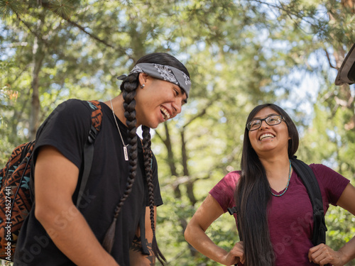 Indigenous young man and woman smiling in nature
