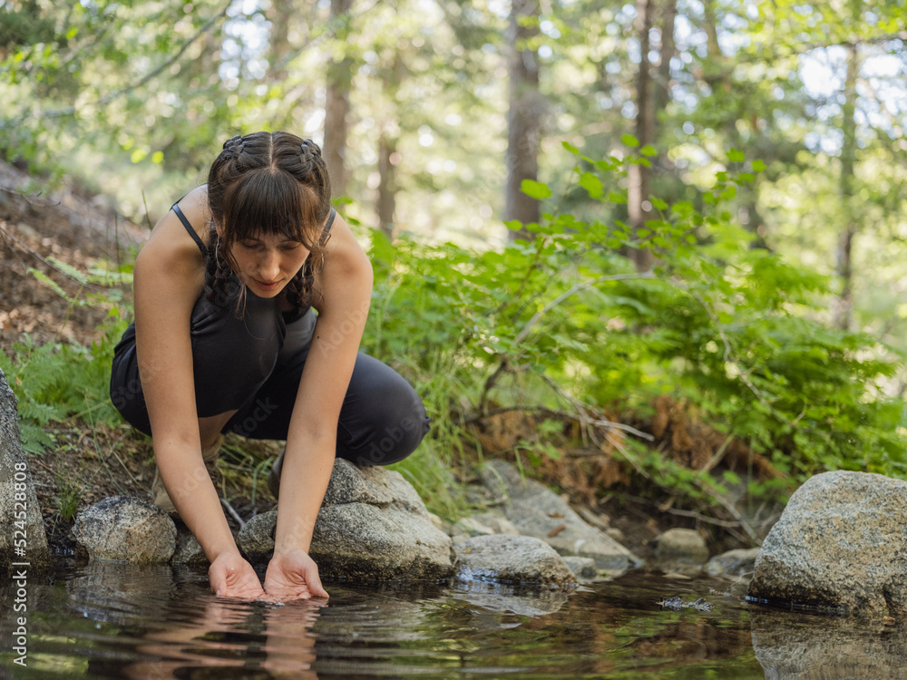 Fototapeta premium Indigenous young woman near a body of water