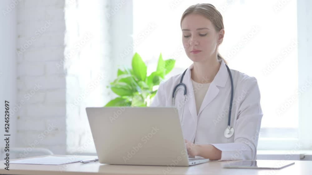 Lady Doctor Working on Laptop in Clinic Lady Doctor Working on Laptop in Clinic