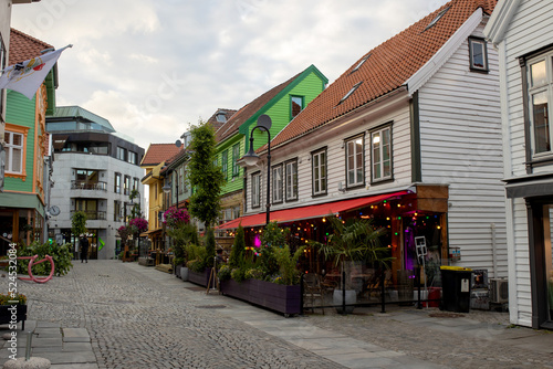 Happy family, children and adults, enjoying the colorful city of Stavangen in Southwest Norway in summer