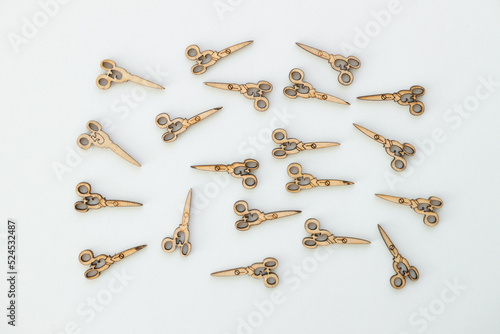 Wooden figures in the form of scissors on a white background
