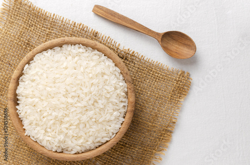 Dry camolino rice in a wooden bowl. The concept of healthy eating. Rustic style. Selective focus. Horizontal orientation. Top view. photo