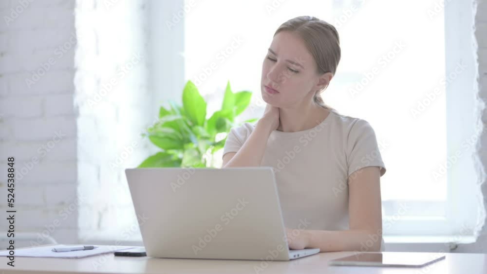 Woman having Neck Pain while using Laptop Woman having Neck Pain while using Laptop