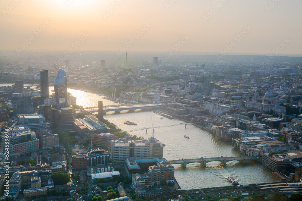 Sunrise in London. City of London view at early morning and beautiful sun reflection in Thames river. UK