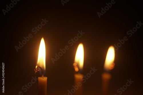 candles burn in the dark close up