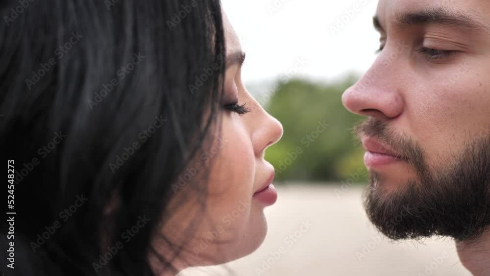 Two lovers kiss. The closeness of the couple close-up. Modern love and relationship of a young couple Two lovers kiss. The closeness of the couple close-up. Modern love and relationship of a young couple