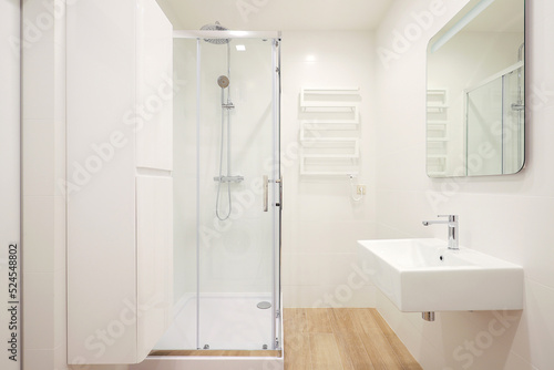Modern bathroom interior with shower cabin and washbasin