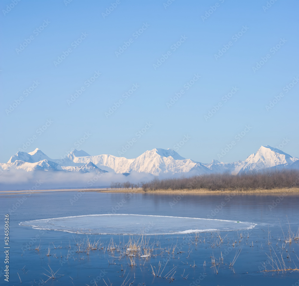 frozen lake in mountain valley, winter mountain natural background