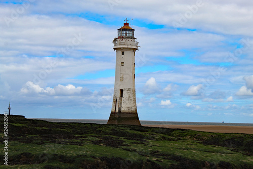 A landscape shot of the lighthouse at New Brighton Beach. The tower is approximately 100 metres tall and was used to guide ships for centuries before finally being decommissioned.