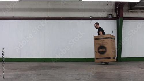 Skateboarding While Stuck In a Large Cardboard Box photo