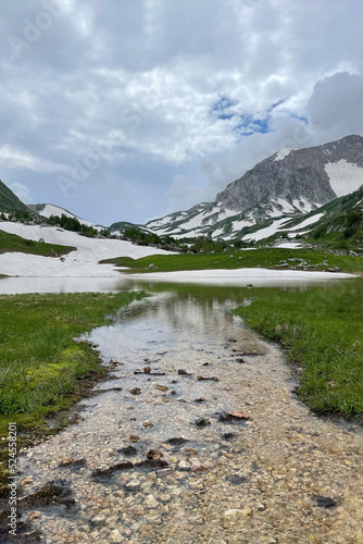 mountain lake among snowy peaks