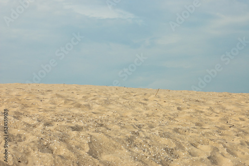 sand mountain, in the photo a large mountain of sand, blue sky in the background