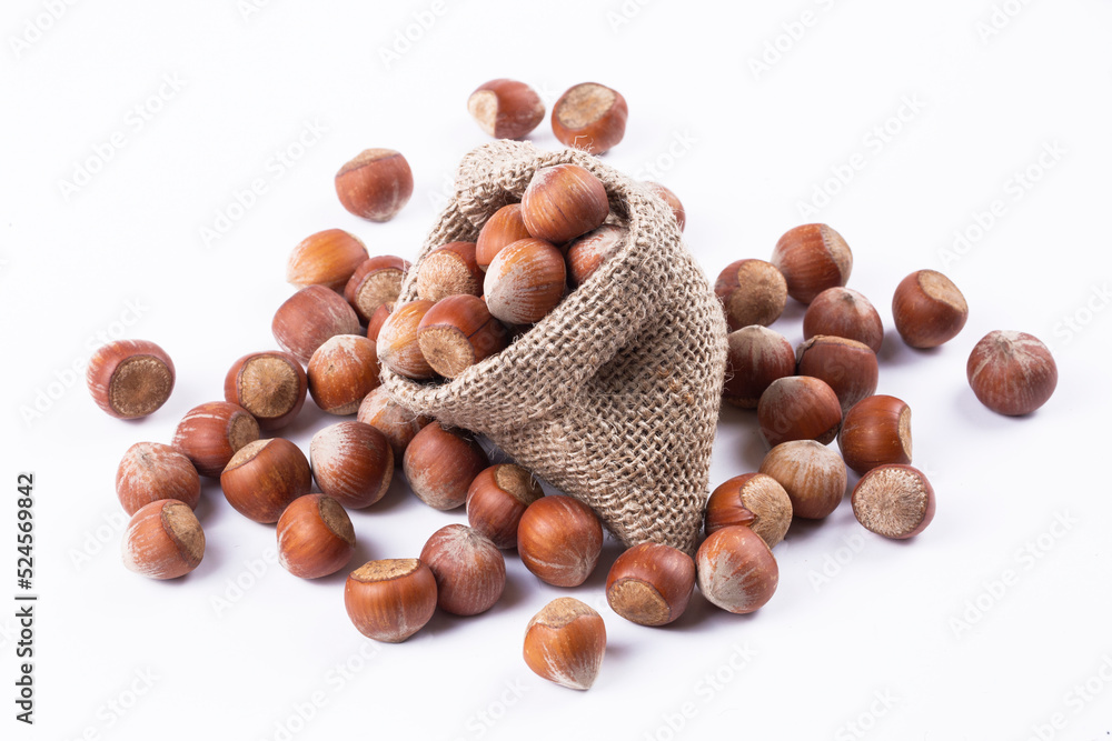 Shelled hazelnuts on the white background