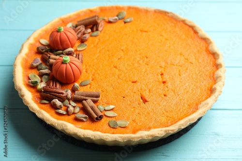 Delicious homemade pumpkin pie on light blue wooden table