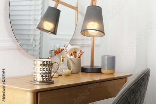Valokuva Mug of hot drink with stylish cup coaster on dressing table in room