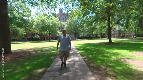 Wallpaper Mural Man walking on Campus tilt up 4K Torontodigital.ca