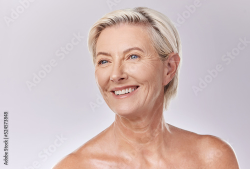 Mature beauty and skin of woman posing in skincare and cosmetics with teeth and smile. Portrait of a happy senior model or elderly lady face in wellness with healthy skin care in a studio.