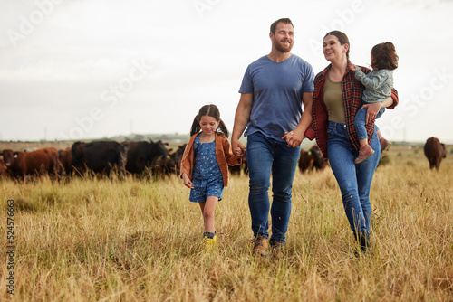 Farmer family, cow farm and bonding mother, father and children on environment or countryside sustainability agriculture field. Happy people and kids walking by cattle for meat, beef or food industry