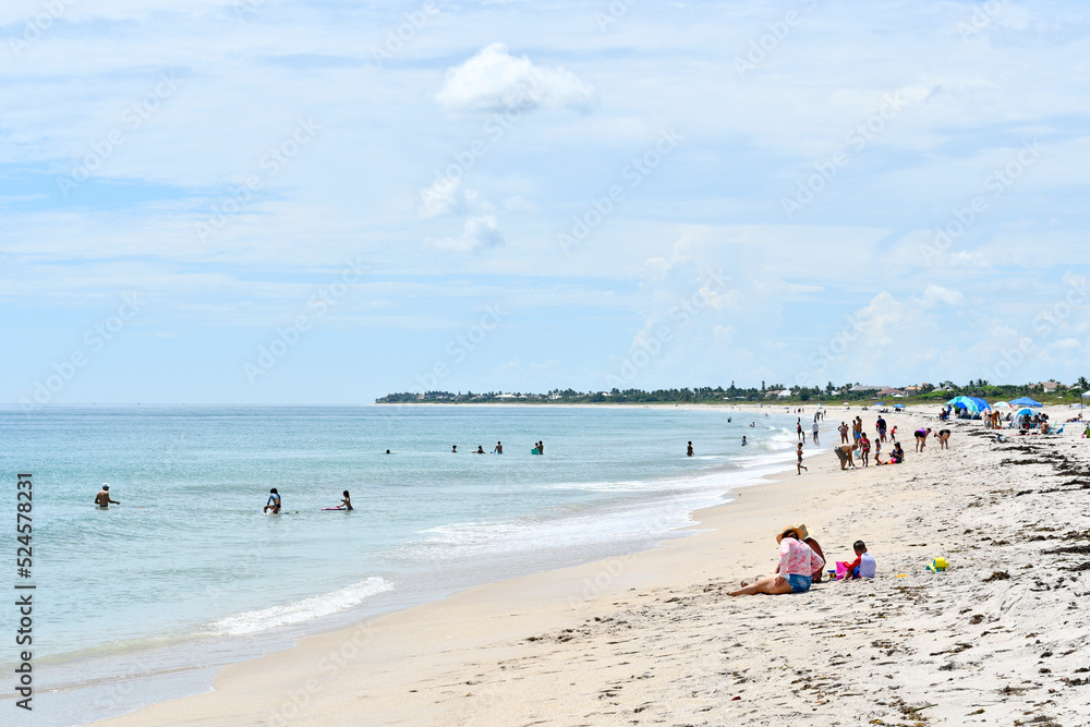 People enjoying a relaxing beach day in Vero Beach, Florida on Hutchinson Island