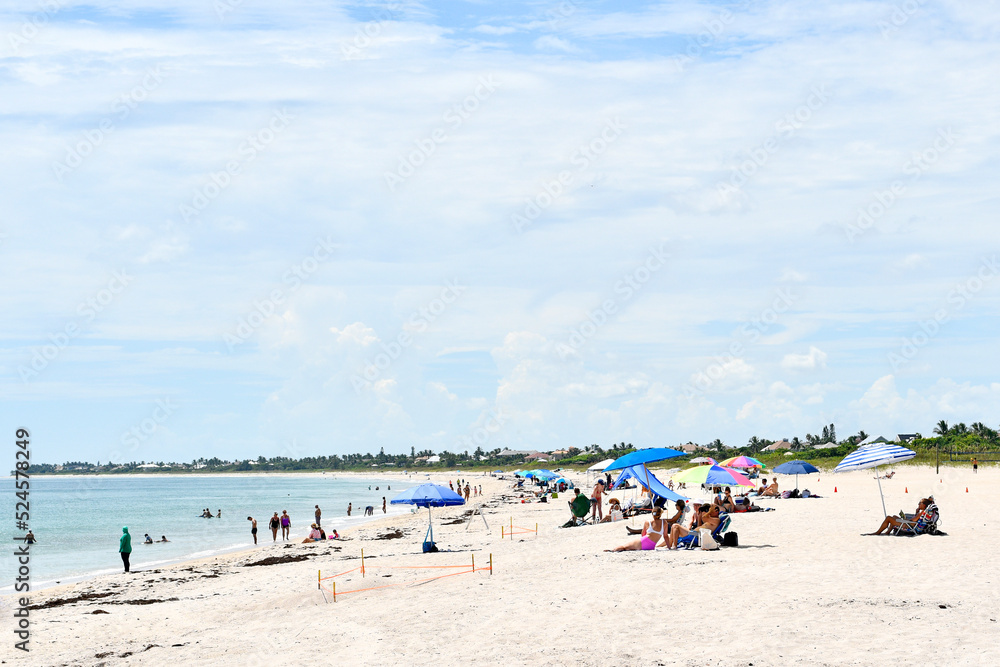 People enjoying a sunny beach day in Vero Beach, Florida on Hutchinson Island People enjoying a sunny beach day in Vero Beach, Florida on Hutchinson Island