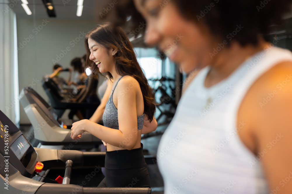 Young asian woman exercising on treadmill at a gym.Active people running on treadmill. smile and funny emotion. Young asian woman exercising on treadmill at a gym.Active people running on treadmill. smile and funny emotion.