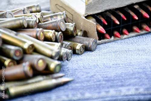 Closeup view of the old bullets on jeans floor, soft and selective focus on bullets, concept for collecting old bullets in free times.