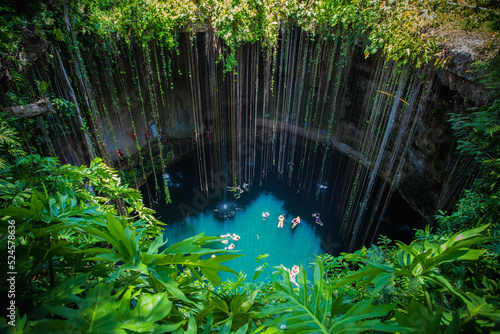 Ik-Kil Cenote, Mexico. Lovely cenote in Yucatan Peninsulla with transparent waters and hanging roots. Chichen Itza, Central America. photo