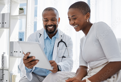 Doctor, healthcare and medicine with a patient talking test results and progress on a tablet in a hospital clinic. Trust, help and medical consulting with a professional medicare worker in his office photo