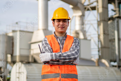 engineer or worker crossing his arms and smiling in the construction site