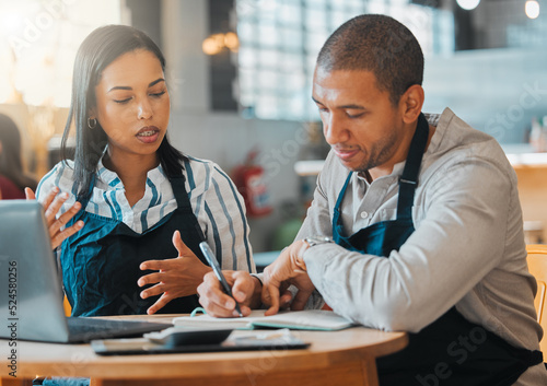 Small business owners discussing and planning startup growth, budget and expenses in the cafe or coffee shop. Entrepreneurs having a financial discussion about the business finance strategy