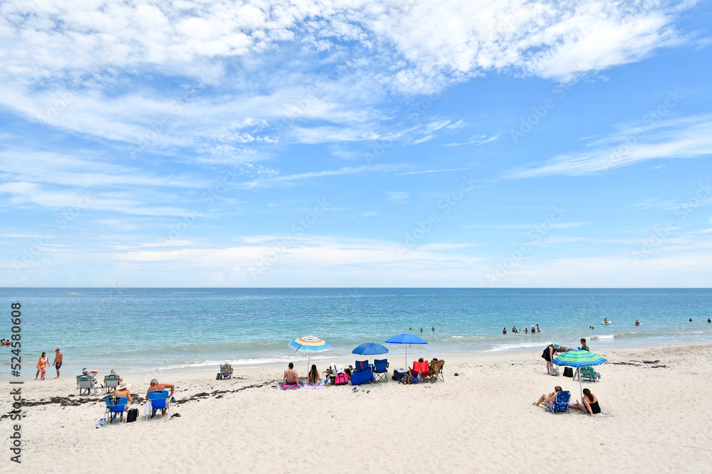 Families enjoying a warm, sunny day at Vero Beach, Florida on Hutchinson Island Families enjoying a warm, sunny day at Vero Beach, Florida on Hutchinson Island