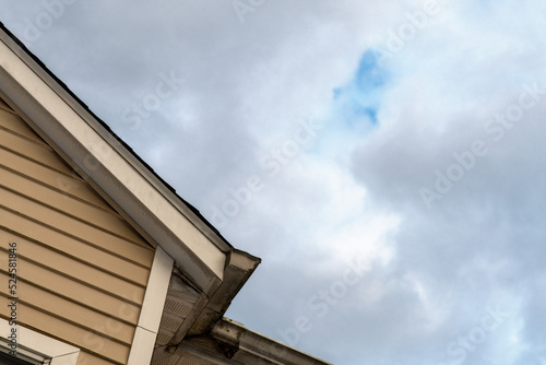 Corner of a house with a cloudy sky 